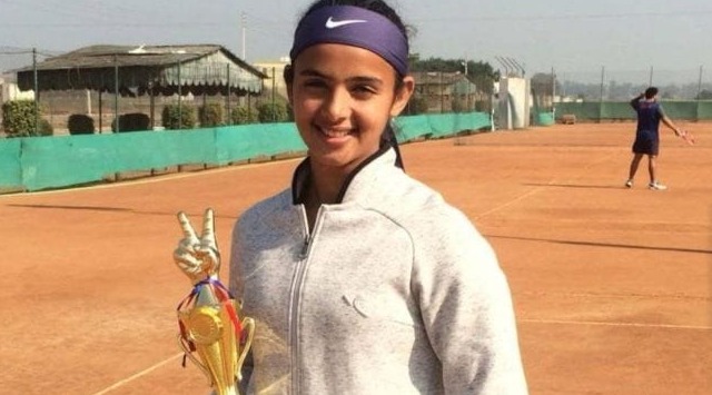 Candlelight vigil for Radhika Yadav with placards reading “End Patriarchy” and “Justice for Radhika”